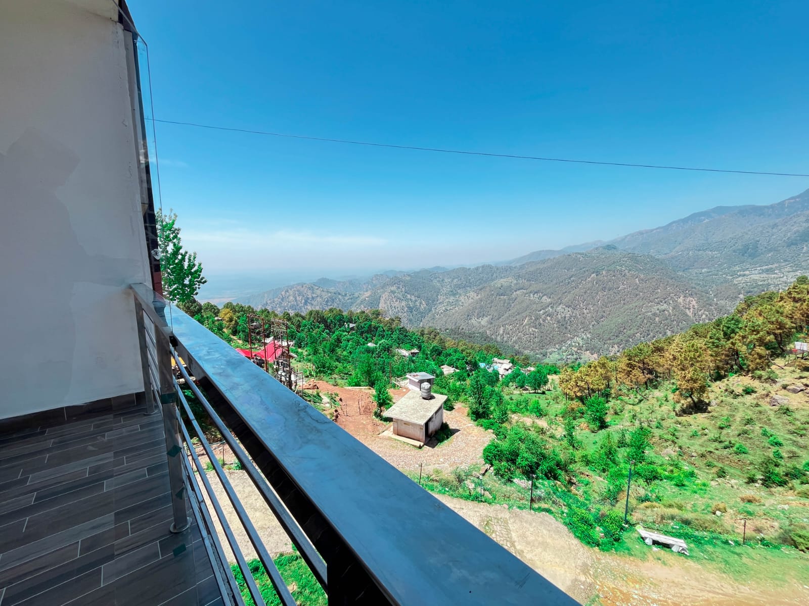 Green hills and valley view from a balcony at Hotel Naddi Hills